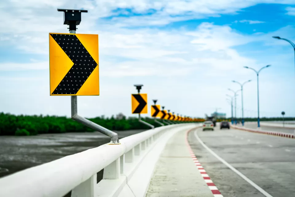 Close-up of curve ahead sign on highway